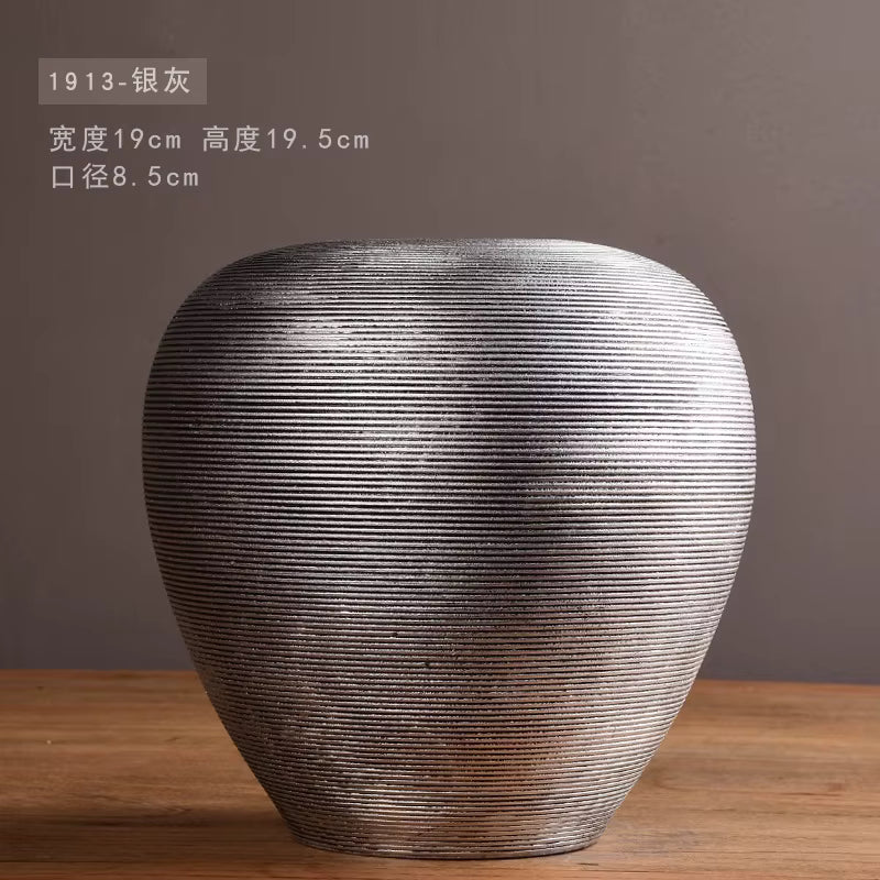 Textured vase on a wooden surface with a dark background