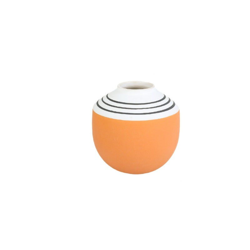 Vase with orange base and white top with black stripes on a white background