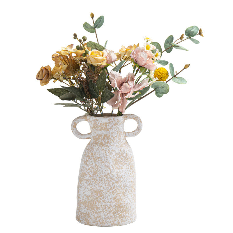 Decorative vase with floral arrangement on a white background