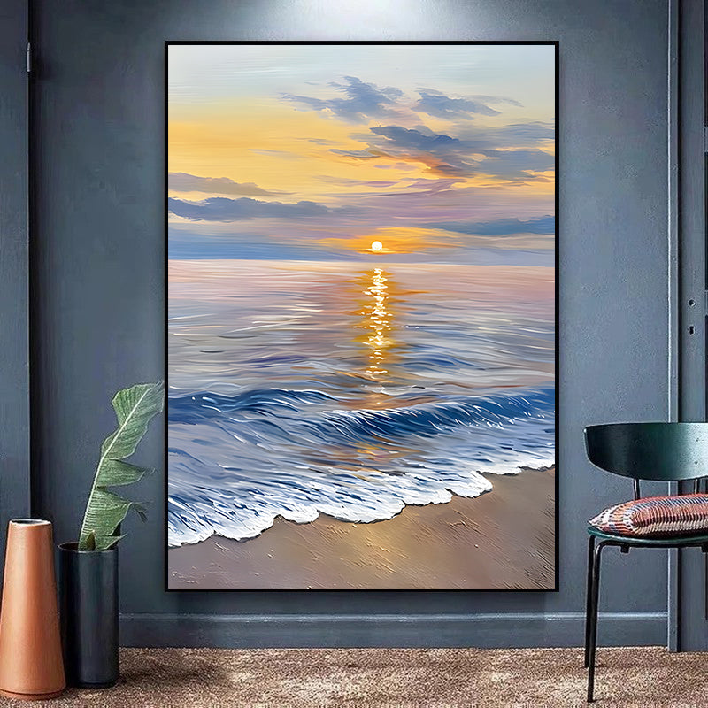 Framed artwork of a sunset over the ocean on a wall in a room with decor elements.