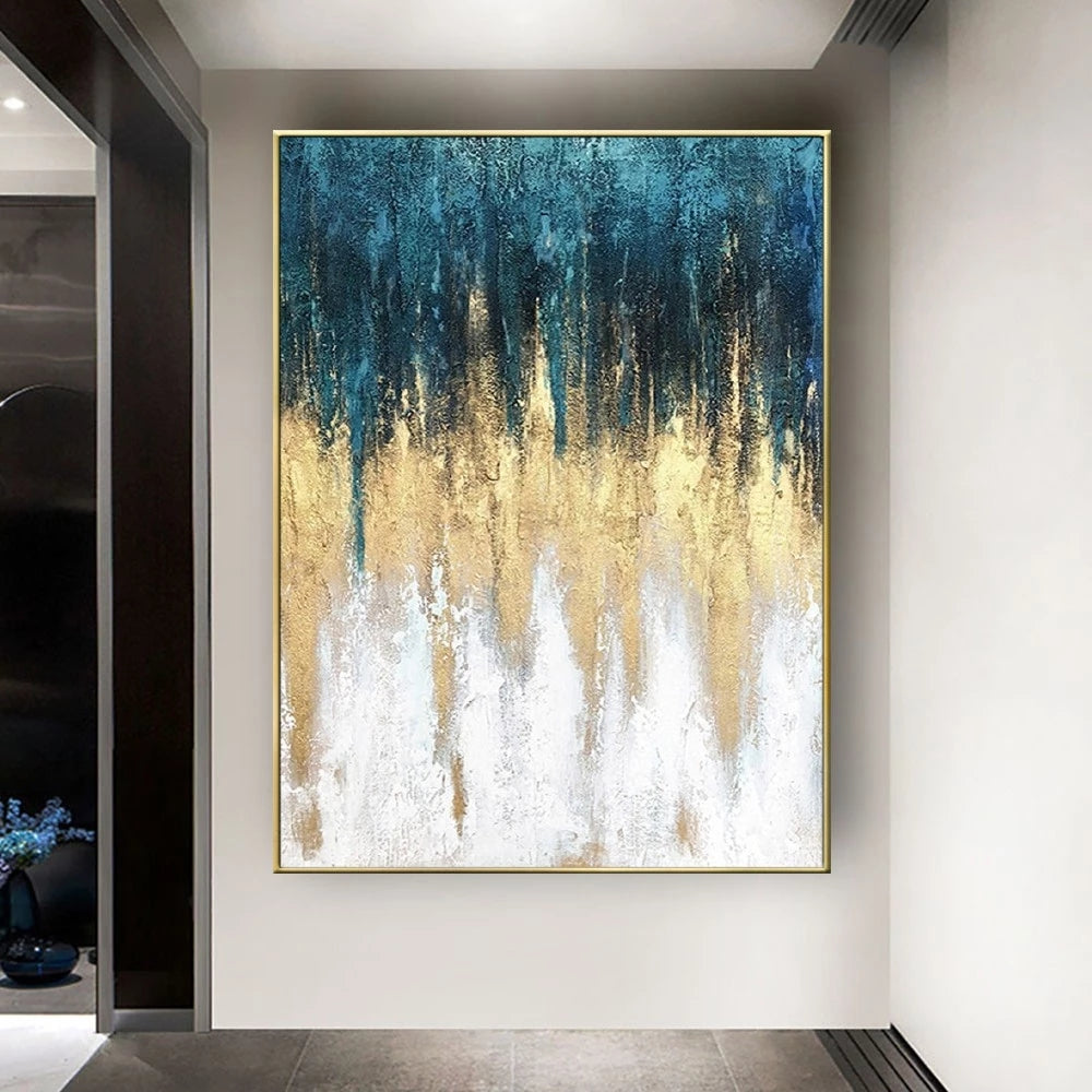Abstract art painting with blue, gold, and white colors on a wall.