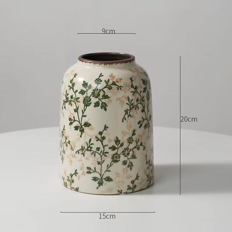 Ceramic vase with floral patterns and dimensions on a gray background