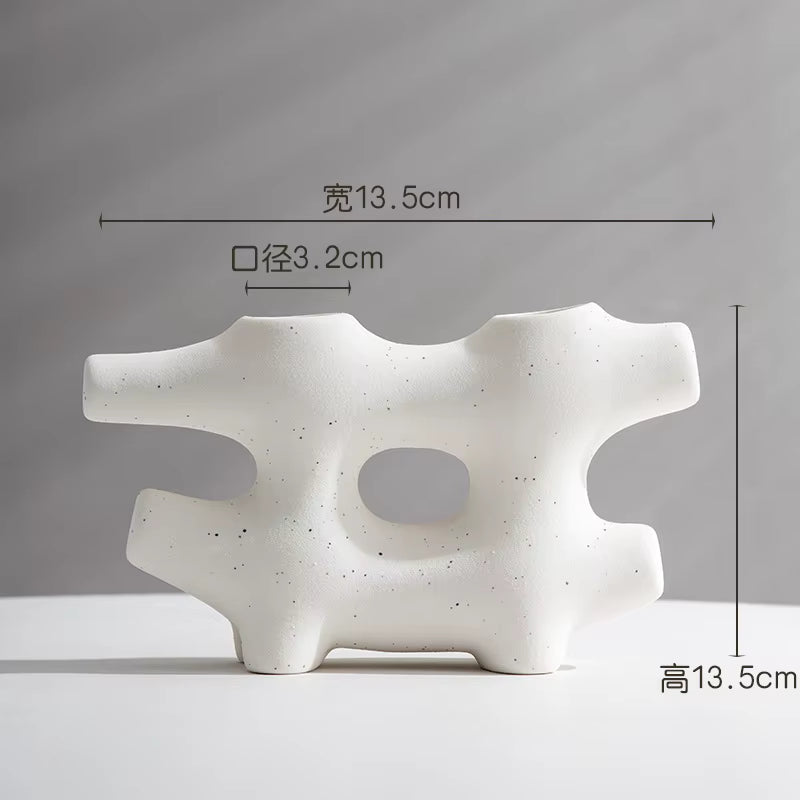 White abstract ceramic sculpture with dimensions on a gray background