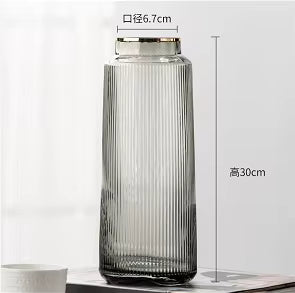 Glass jar with ribbed design and measurements on a white background