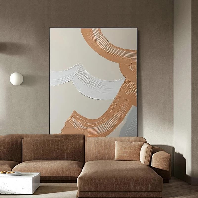 Abstract art piece on a wall above a brown sofa in a modern living room.