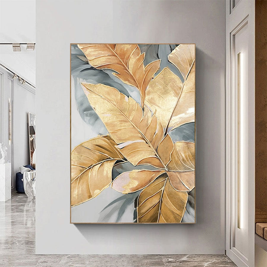 Decorative wall art with gold and gray leaves in a modern interior setting.