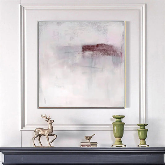 Decorative setup with abstract art, deer figurine, and green urns on a white wall.
