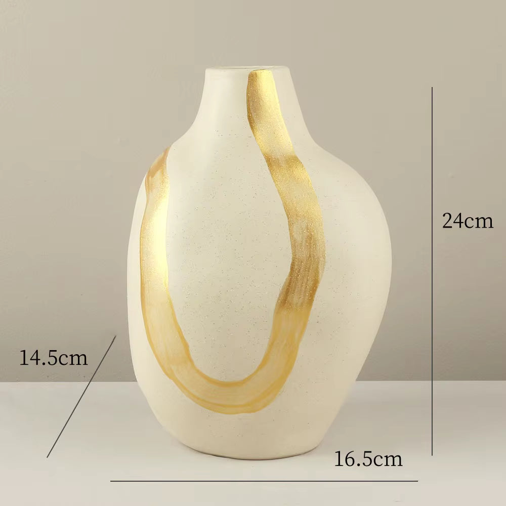 White vase with gold accents on a neutral background, showing measurements.