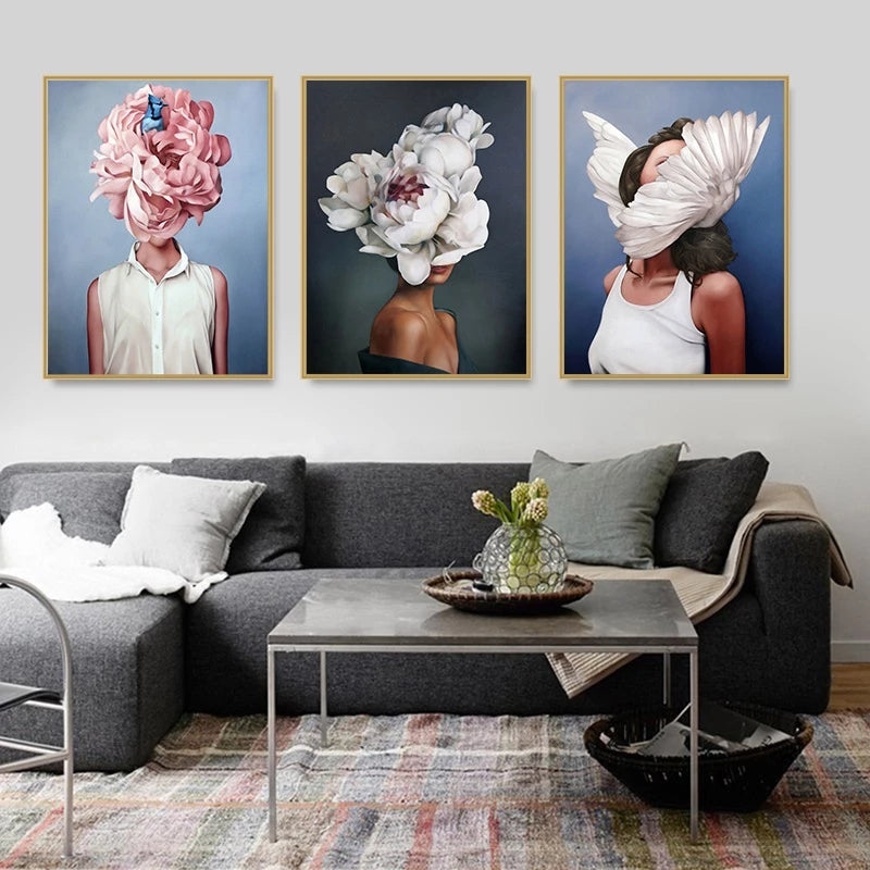 Living room with a gray sectional sofa, coffee table, and wall art featuring people with floral heads.