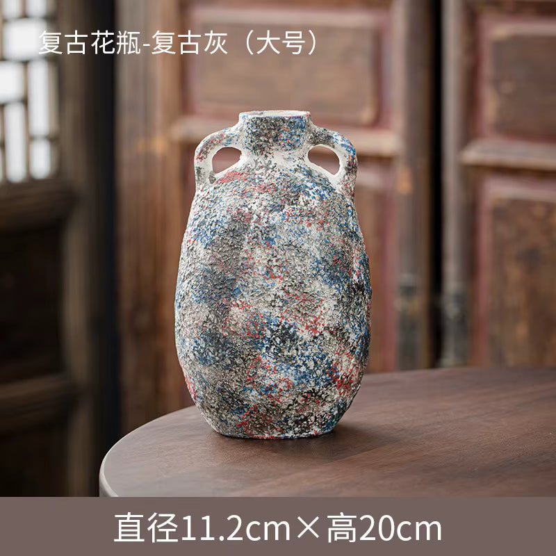 Decorative vase with multicolored speckles on a wooden surface with a blurred background