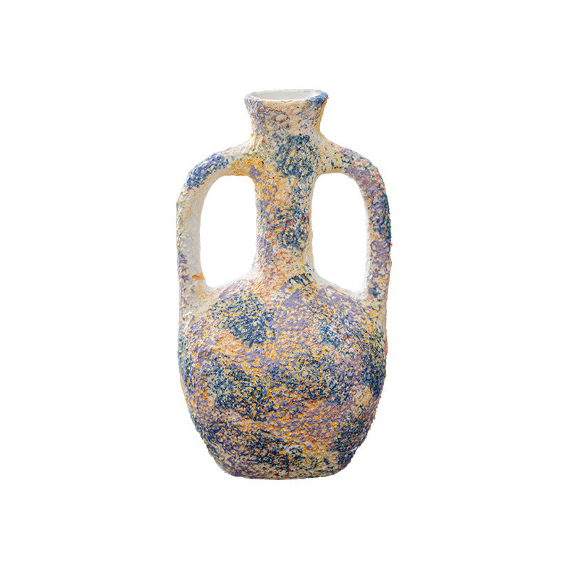 Decorative vase with a speckled pattern on a white background