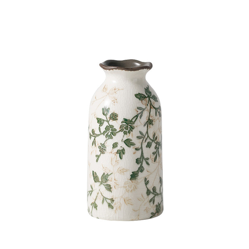 Decorative vase with green leaf patterns on a white background