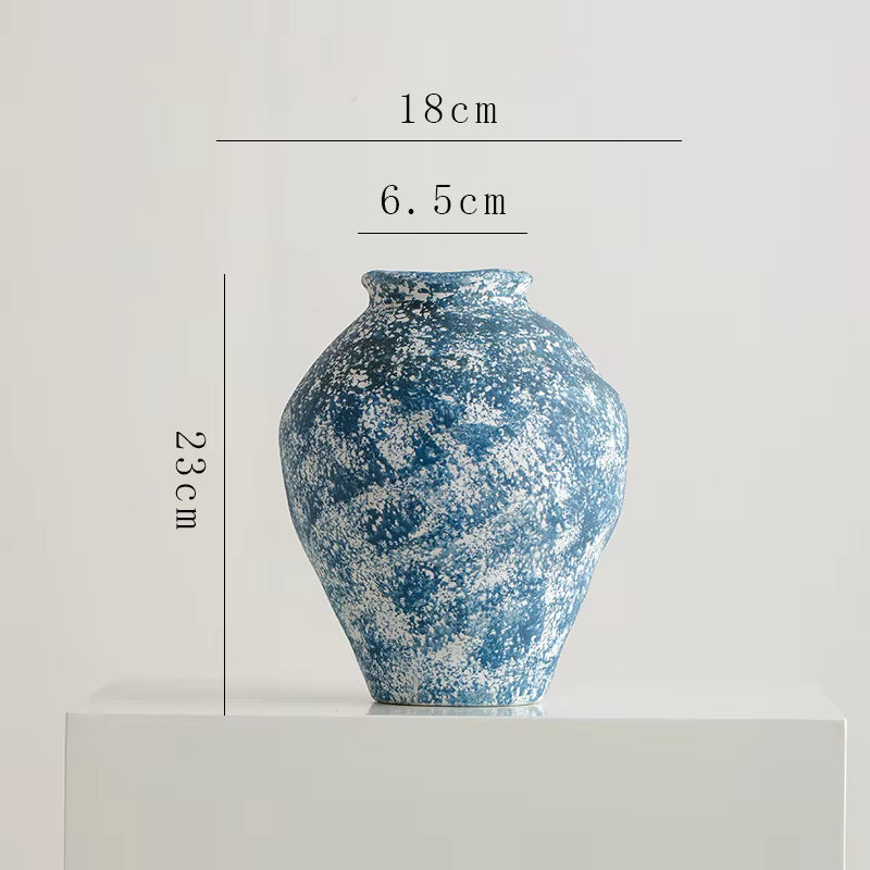 Blue ceramic vase with measurements on a light gray background