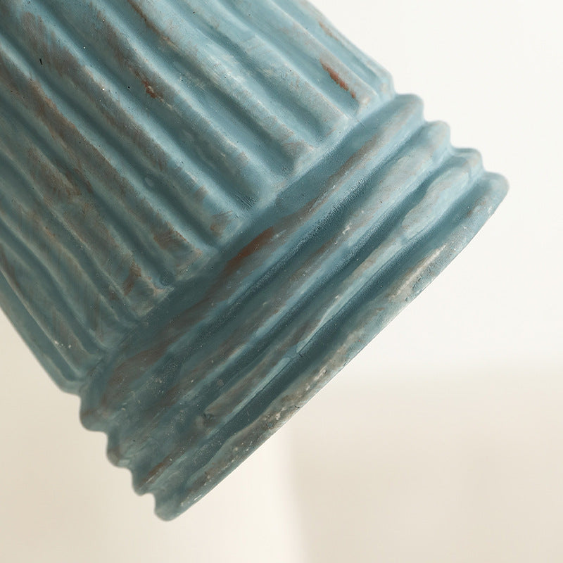 Textured blue ceramic object on a light beige background