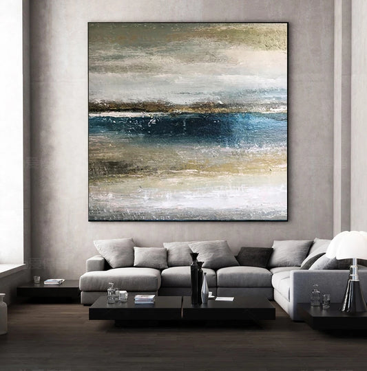 Abstract painting on a wall above a gray sectional sofa in a modern living room.