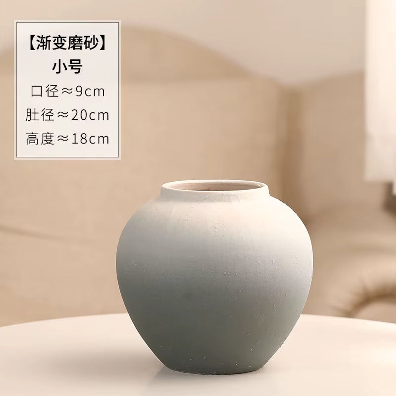 Gray ceramic vase on a beige background with text overlay