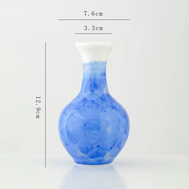 Blue ceramic vase with measurements on a white background