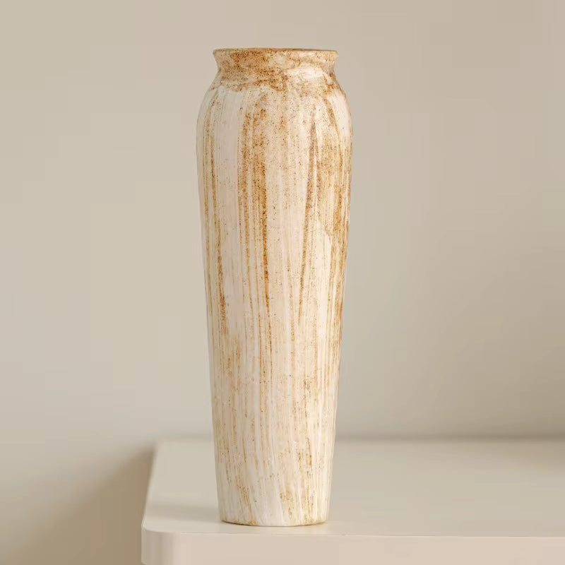 Tall ceramic vase with a textured surface on a neutral background