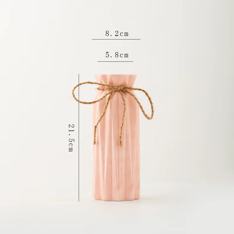 Pink bottle with twine measurement details on a white background
