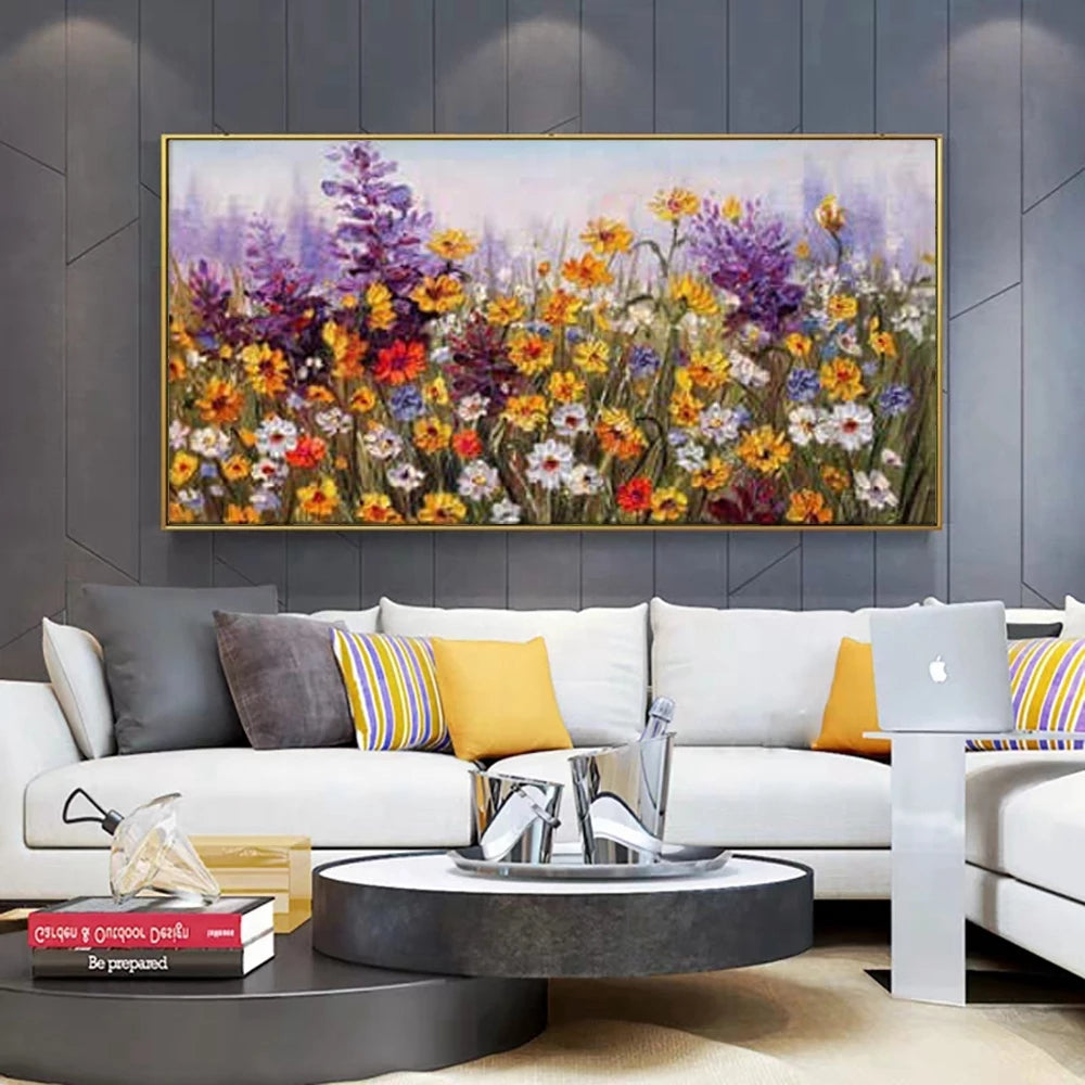 Living room with a large floral painting on the wall above a white sofa.
