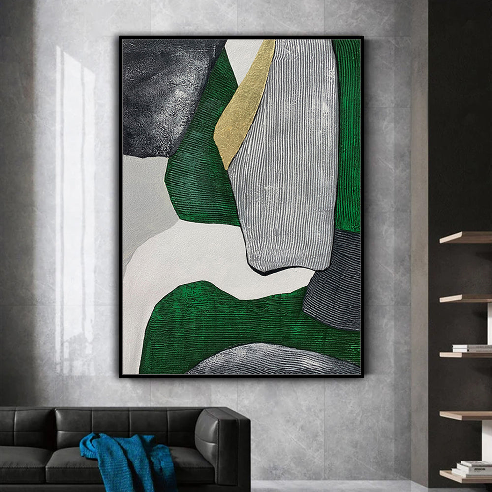 Abstract art piece with green, gold, and gray colors on a wall above a sofa.