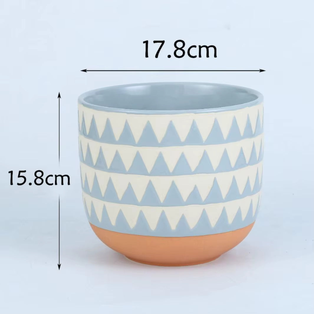 Ceramic cup with geometric pattern and measurements on a light blue background