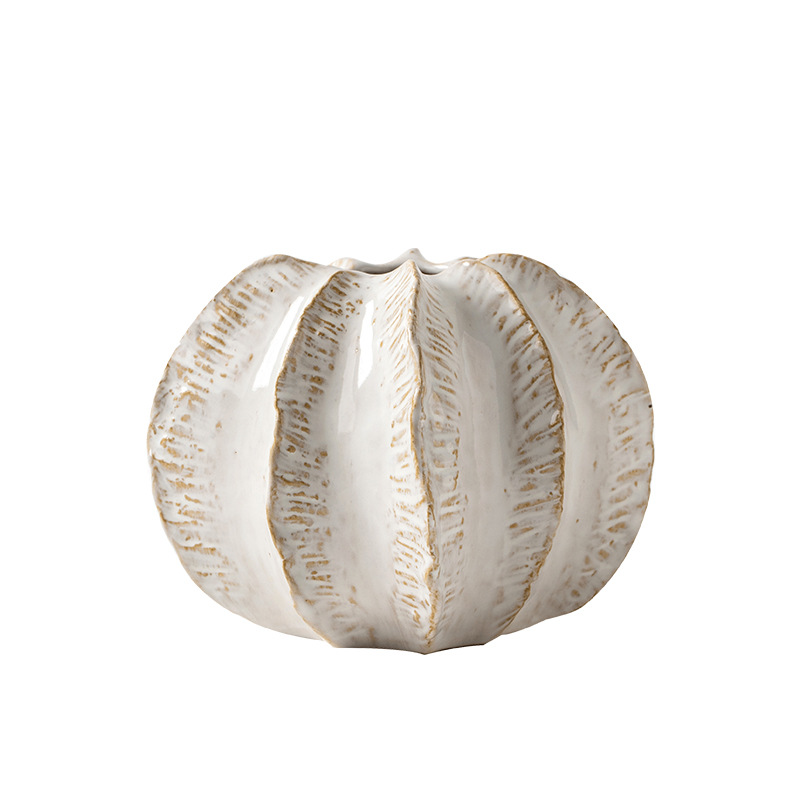 Decorative ceramic vase with textured surface on a white background
