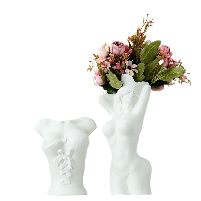 White hand-shaped vase holding a bouquet of flowers on a white background