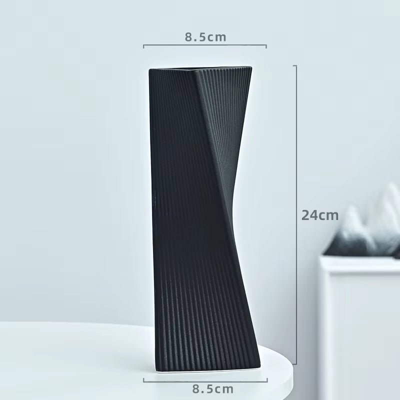 Black textured vase with dimensions on a light gray background