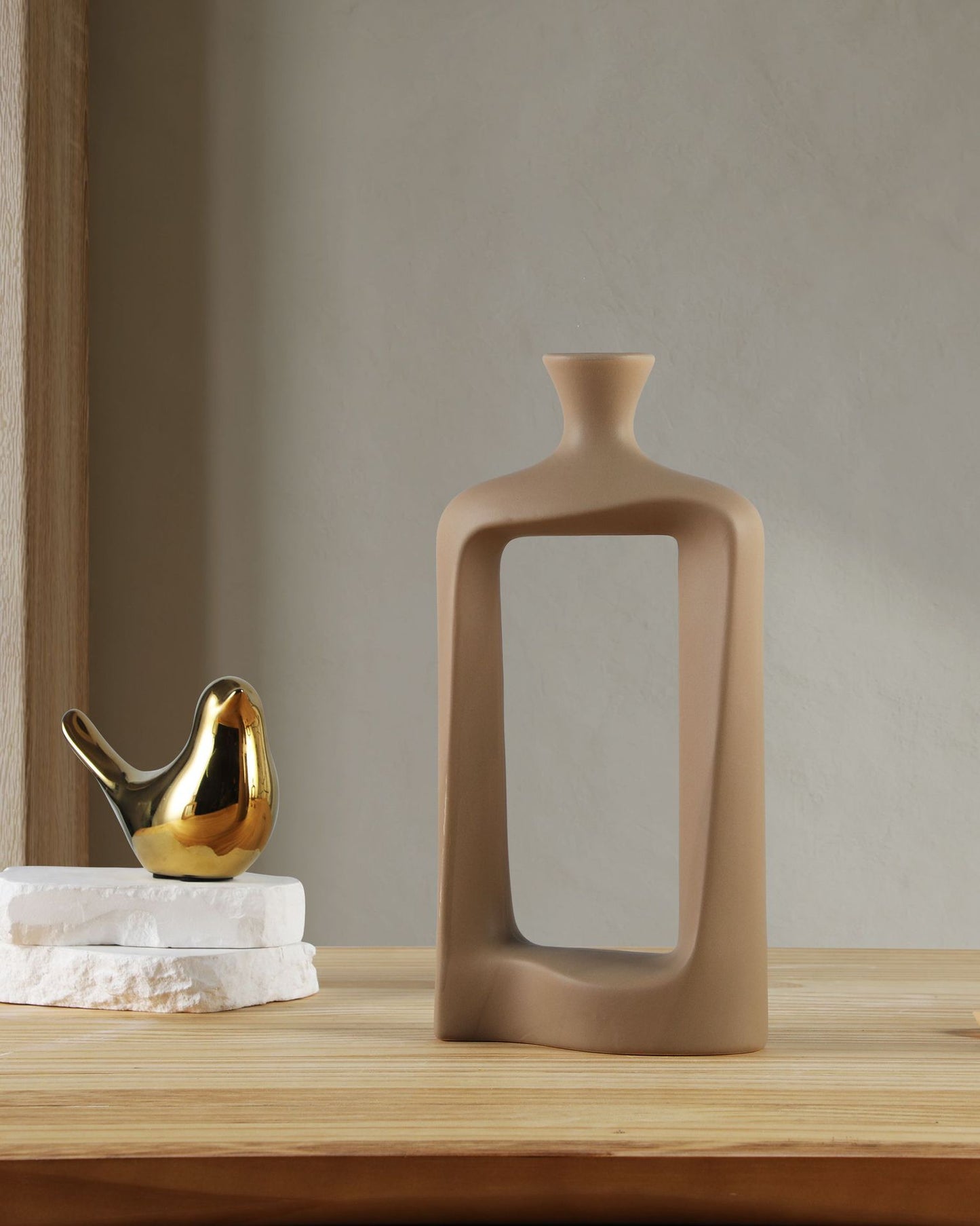 Decorative vase on a wooden surface with a neutral background