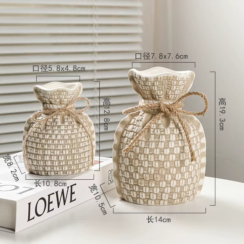 Two woven bags with measurements on a LOEWE box
