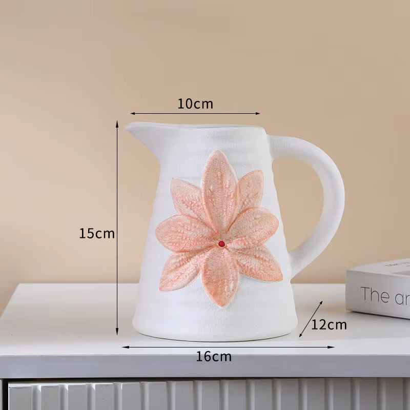 White ceramic pitcher with a pink floral design and measurements on a beige background