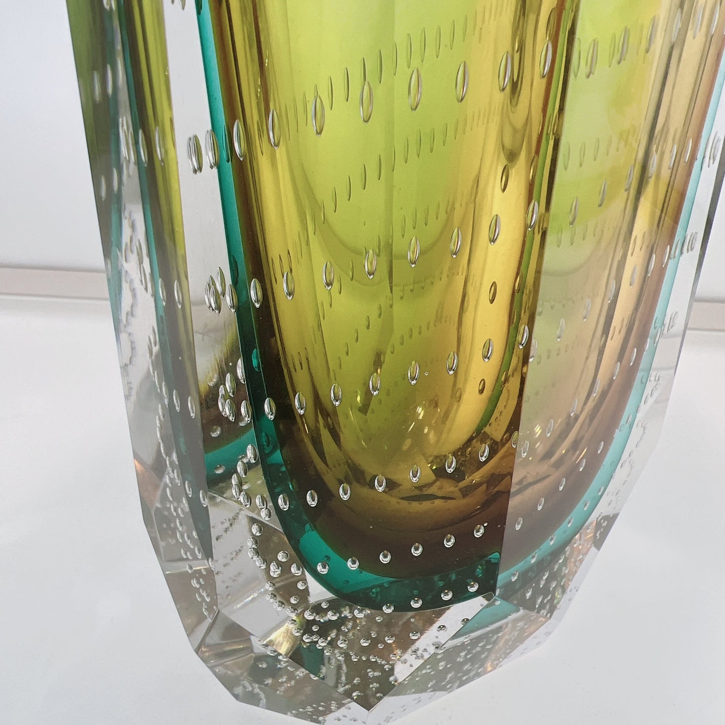 Close-up of a glass vase with a textured surface and reflective properties.