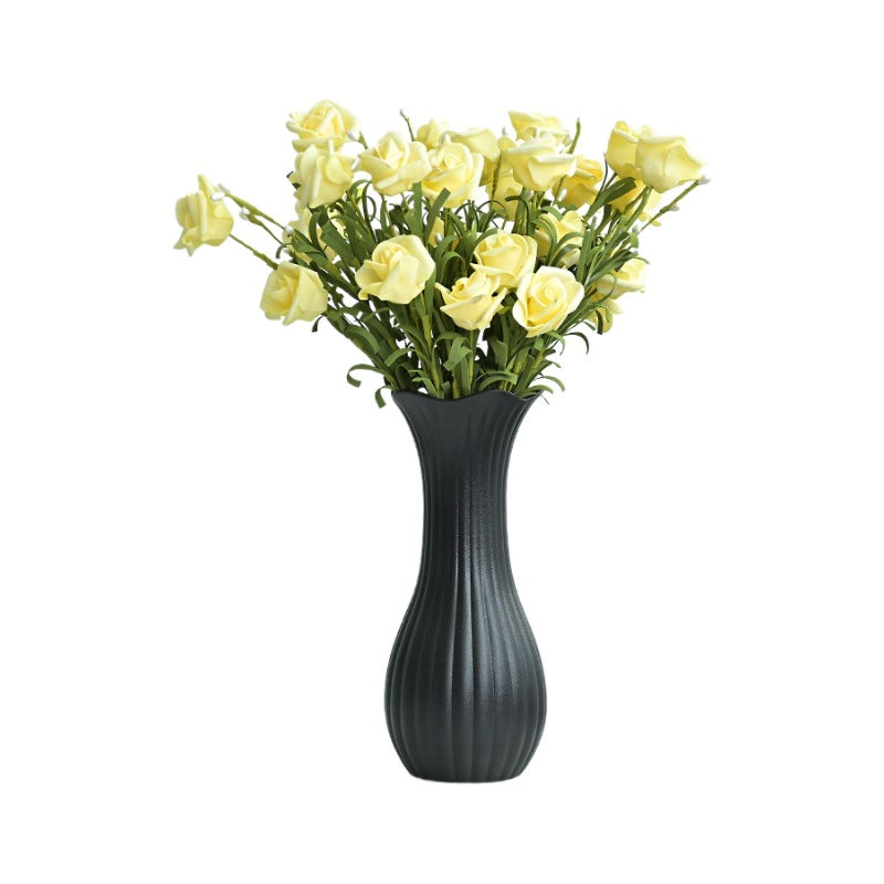 Gray vase with yellow flowers on a white background