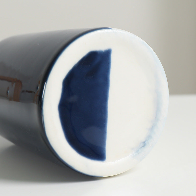Close-up of a ceramic mug with blue interior on a white background