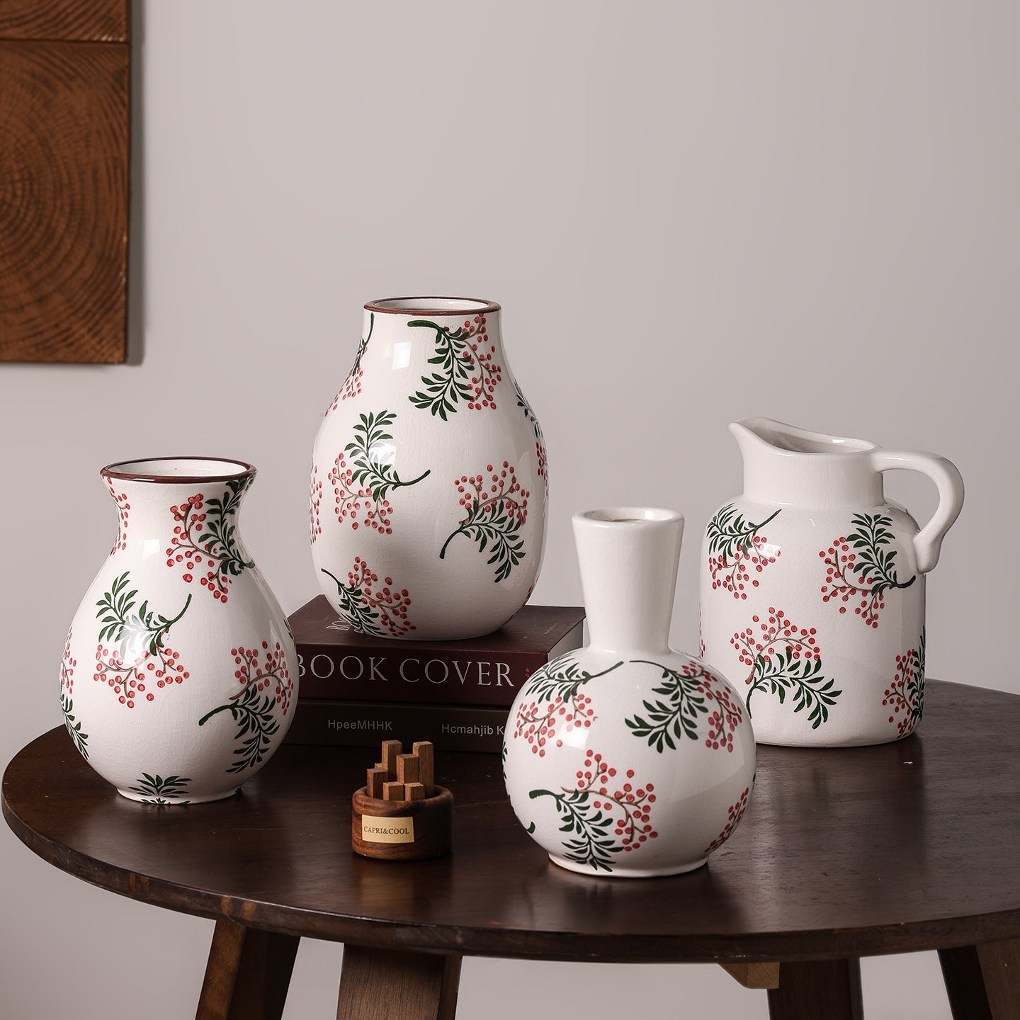 Set of ceramic vases with floral patterns on a wooden table