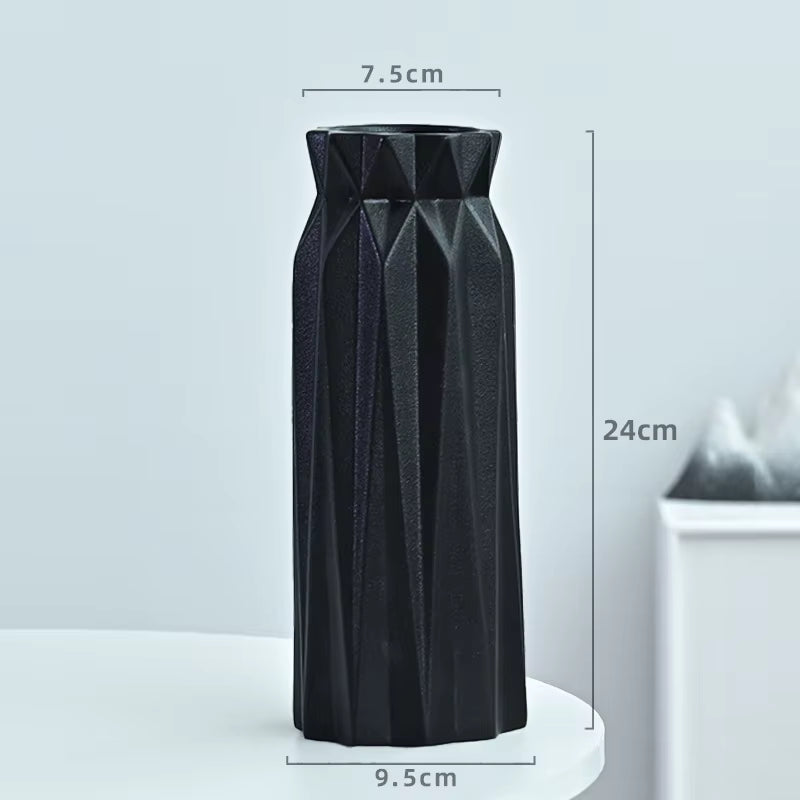 Black textured vase with dimensions on a light gray background