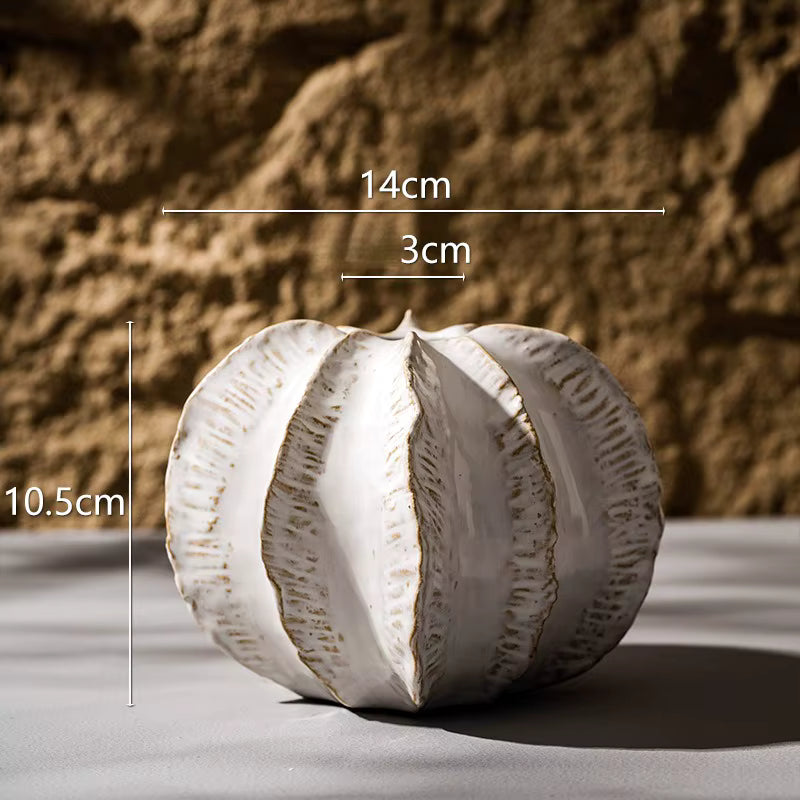 White ceramic ball with measurements on a textured surface