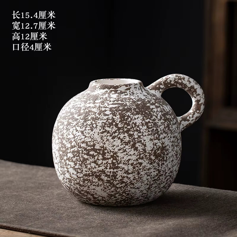 Ceramic mug with speckled design on a dark surface