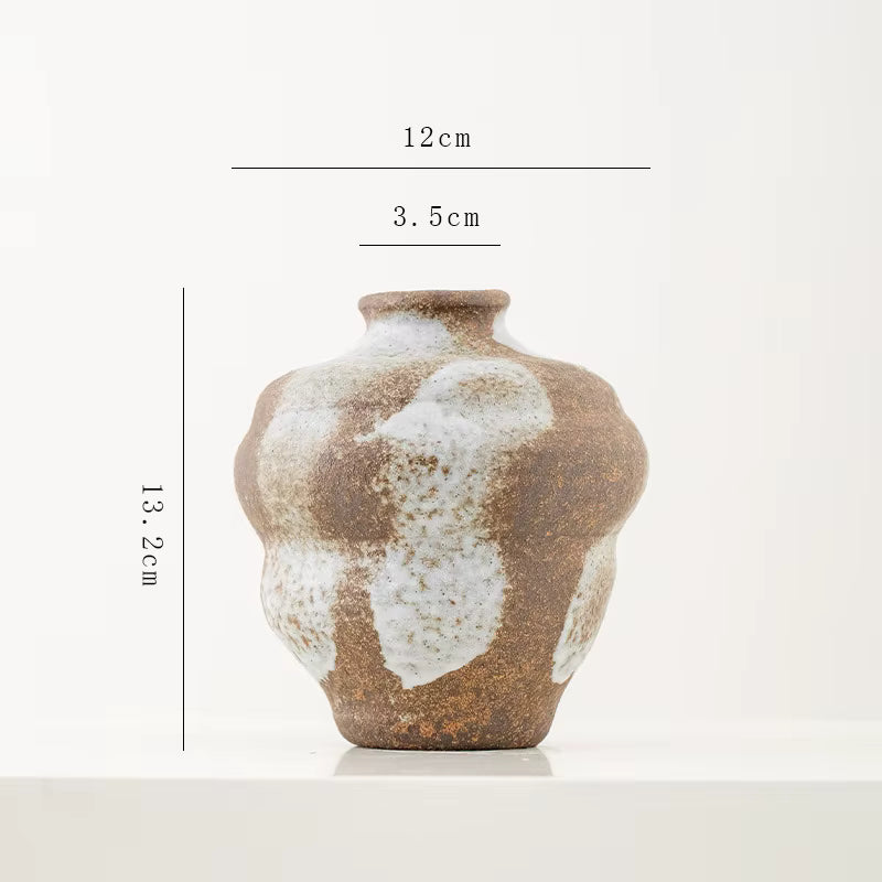 Ceramic vase with measurement markings on a white background