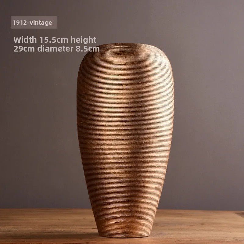 Vintage-style vase on a wooden surface with a dark background