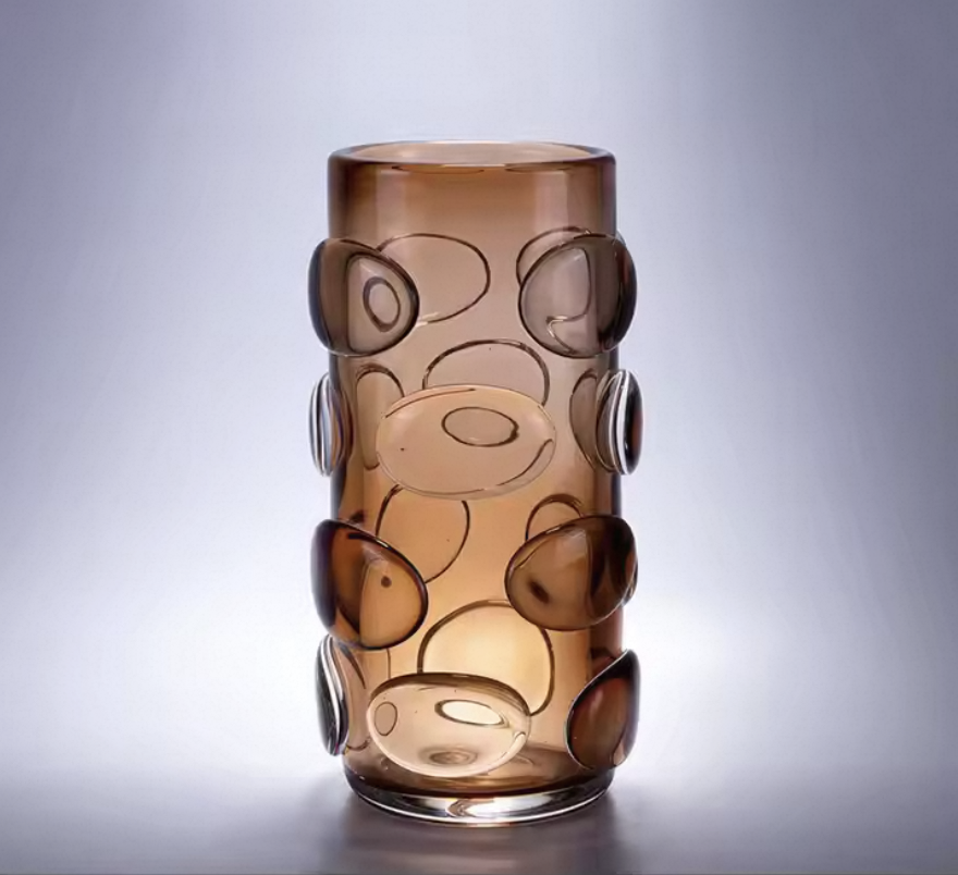 Brown glass vase with circular patterns on a gray background