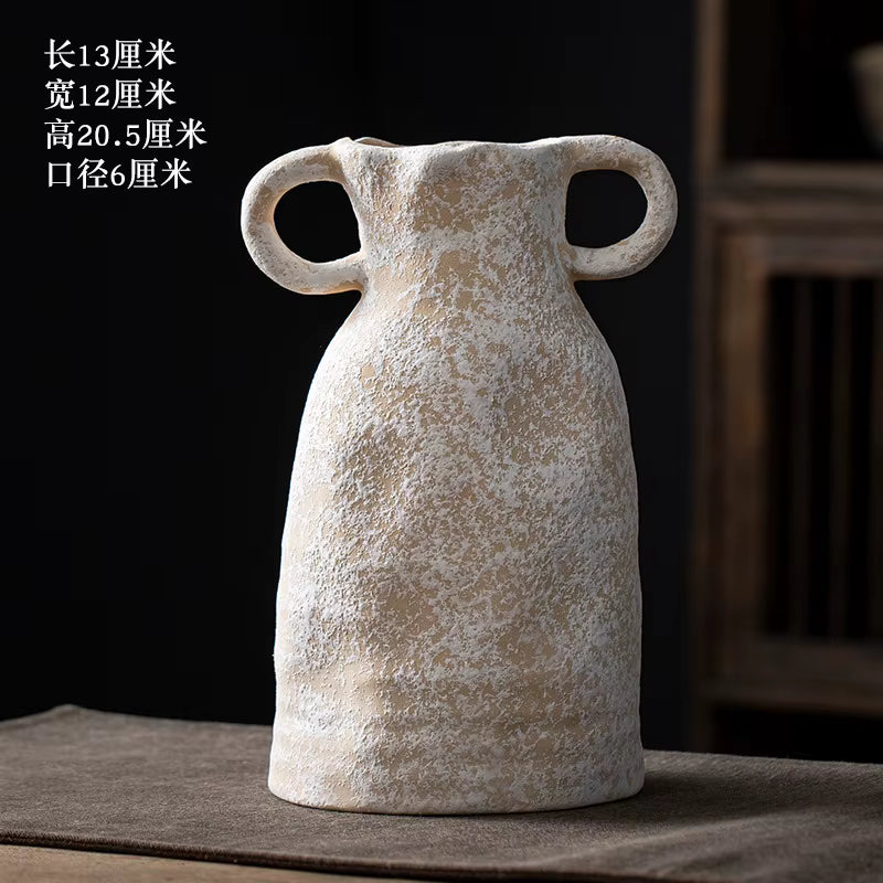 Decorative vase with handles on a dark background
