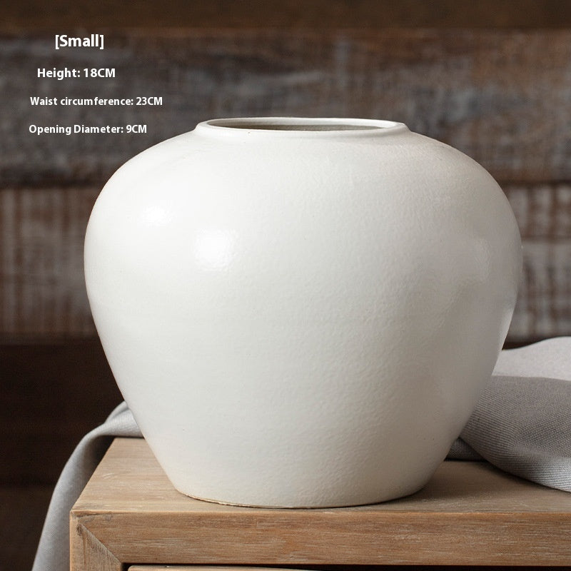 White ceramic vase on a wooden surface with dimensions displayed.