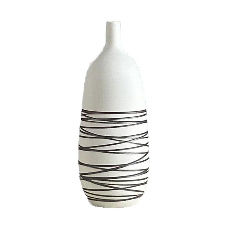 White vase with black wavy patterns on a white background