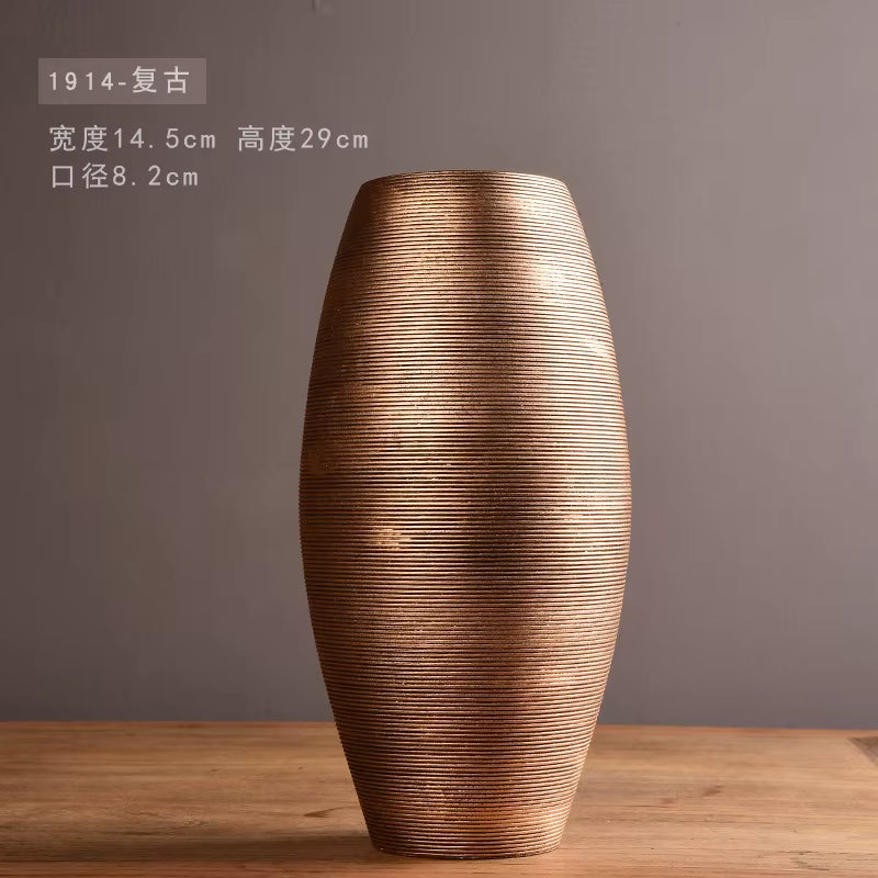 Decorative vase with textured surface on a wooden table against a gray background