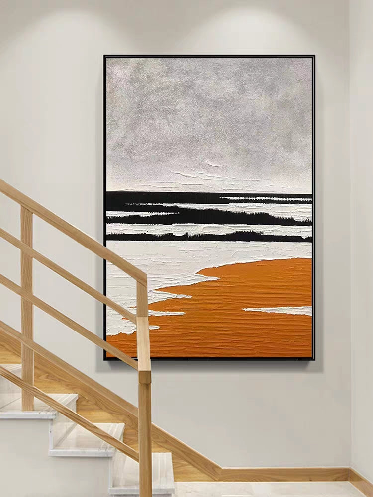 Abstract art piece with black, white, and orange on a wall above a staircase.