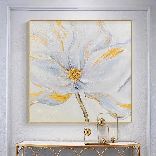 Framed floral artwork on a wall with a gold console table below.