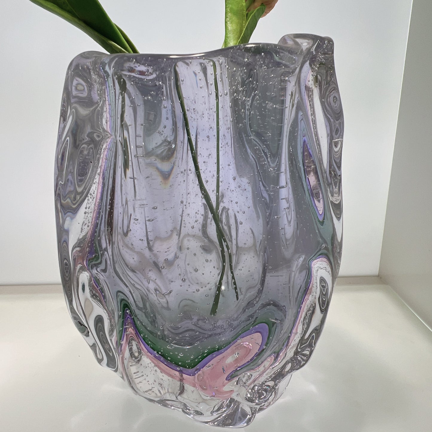 Glass vase with marbled design on a white surface
