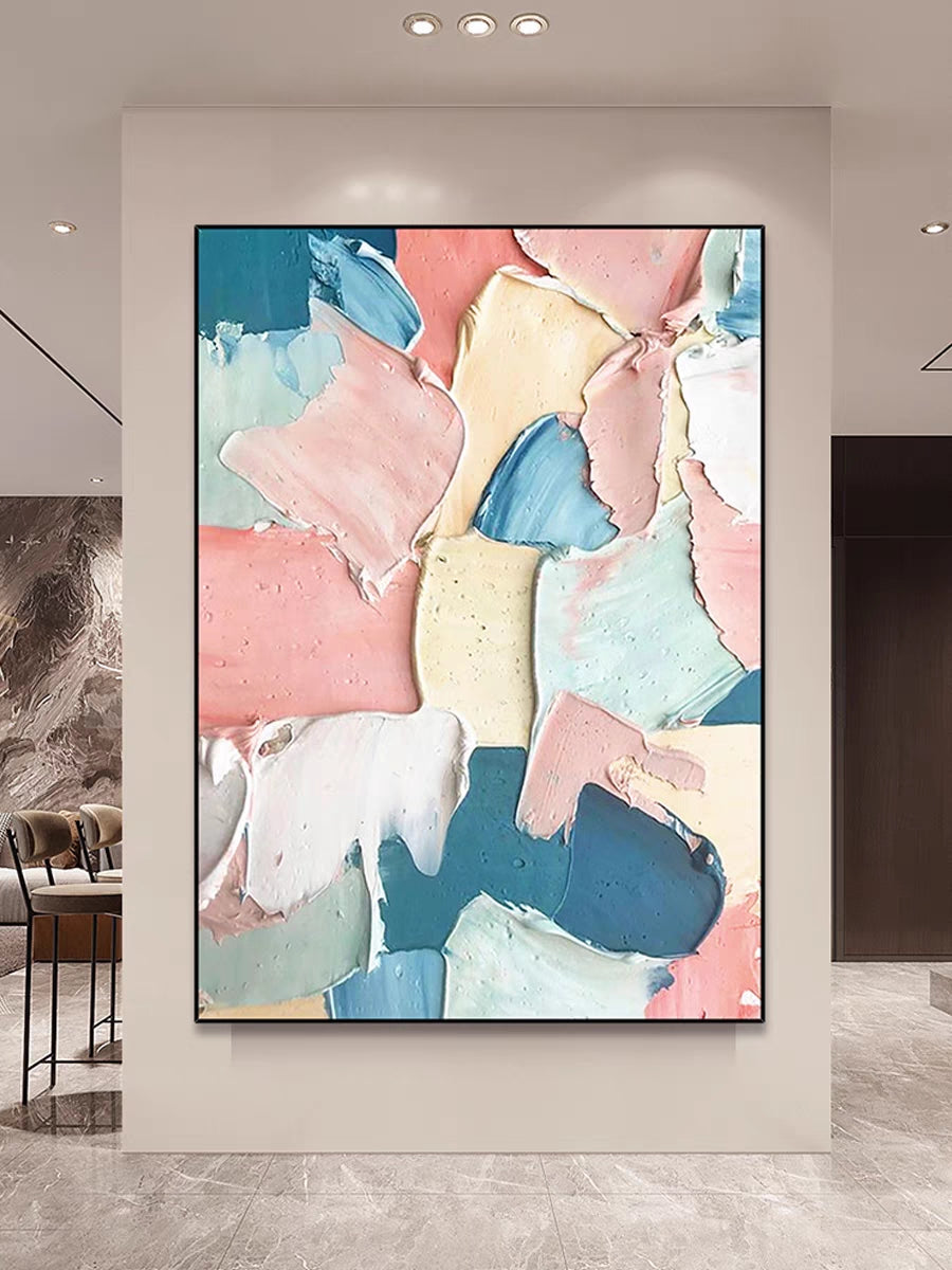 Abstract art piece with pastel colors on a wall in a modern interior setting.